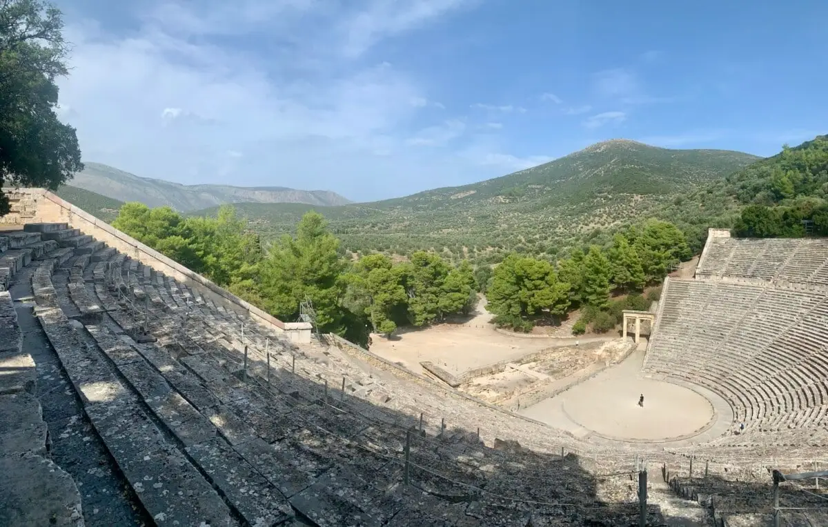 View of the Ancient Theater of Epidaurus surrounded by green hills in Greece