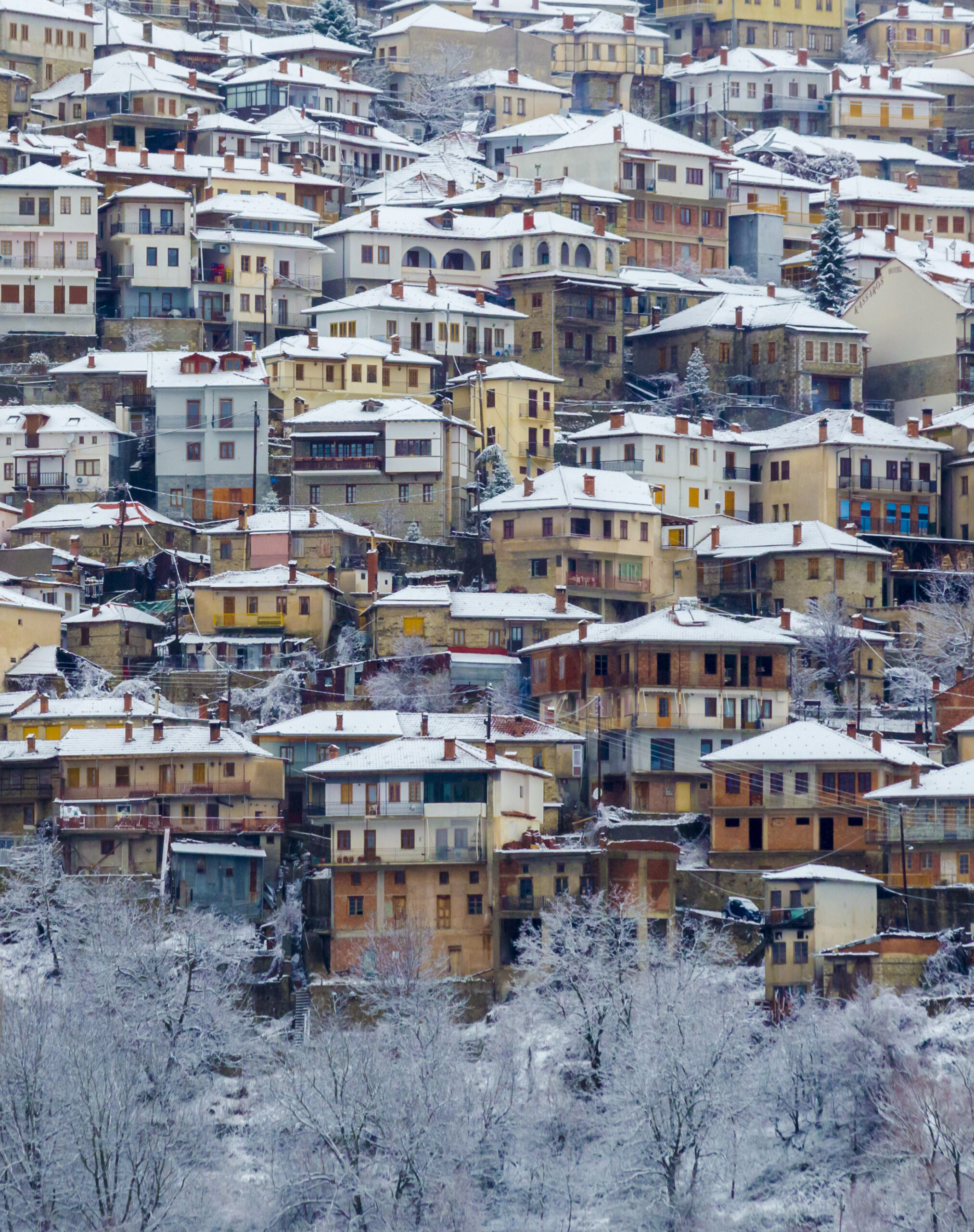Snow-covered traditional houses in Metsovo village, Epirus, Greece during winter